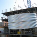 15,000 Litre Squat Galvanised Aquaplate Steel Tank for commercial use bing craned into position at York St, Richmond